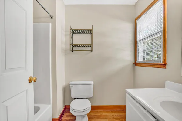 a white toilet sitting next to a bathroom sink