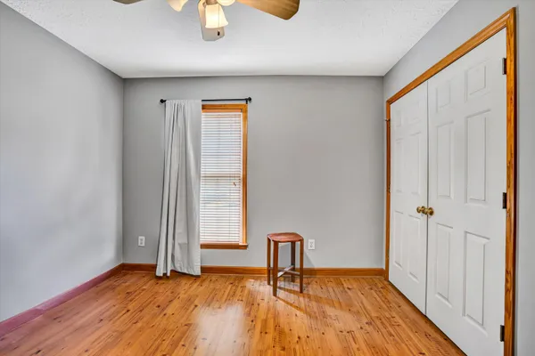 a view of a room with wooden floor and bench
