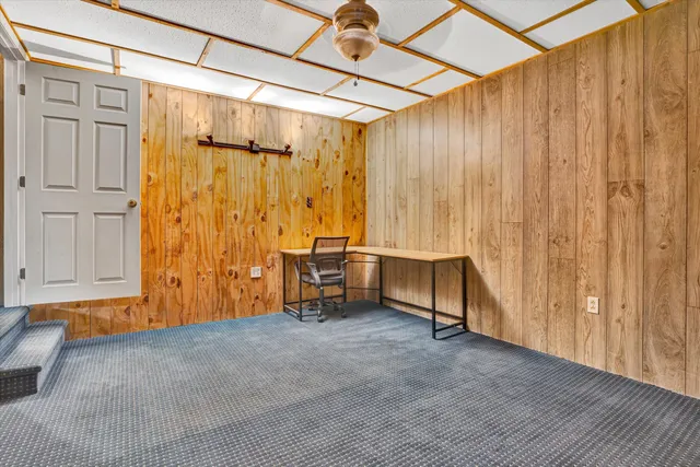 a living room with furniture and kitchen view
