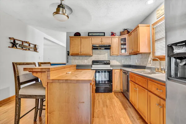 a kitchen with stainless steel appliances granite countertop a stove and a sink