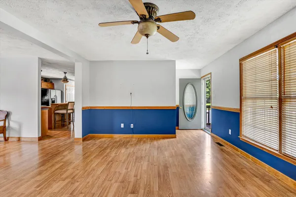 a view of a workspace with furniture and a window