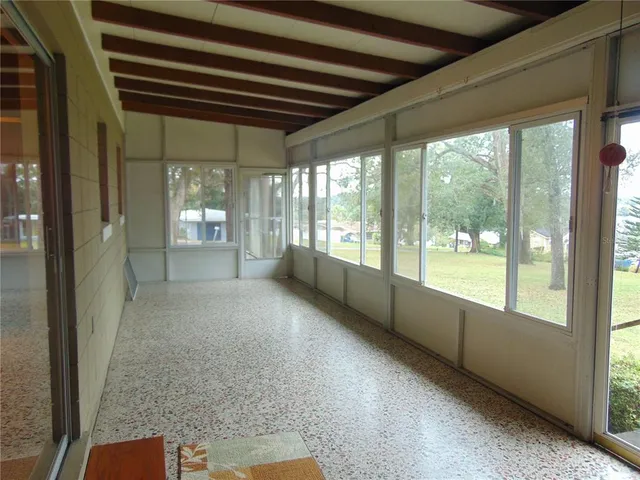 a bathroom with a granite countertop bathtub shower sink vanity and toilet