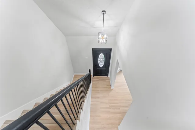 a view of a hallway with a chandelier