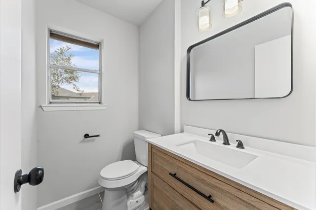 a bathroom with a toilet sink and mirror