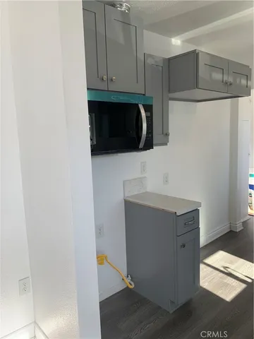 a kitchen with a refrigerator and a stove top oven