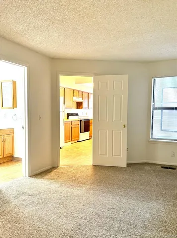 a view of empty room with wooden floor and cabinet