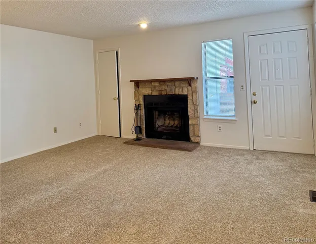 a view of empty room with a fireplace