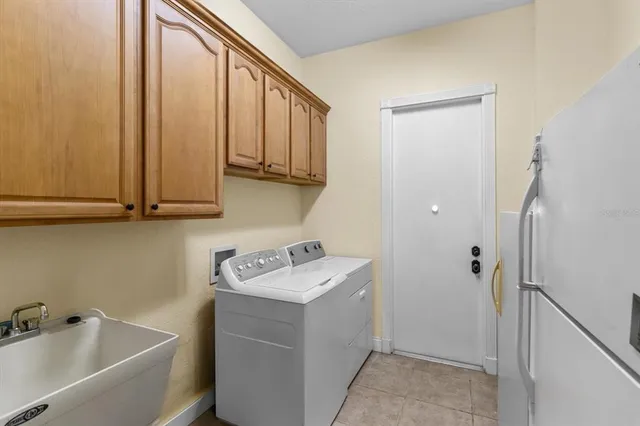 a view of a hallway with furniture and a chandelier fan