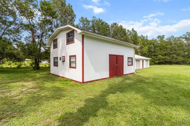 an aerial view of a house with swimming pool and garden