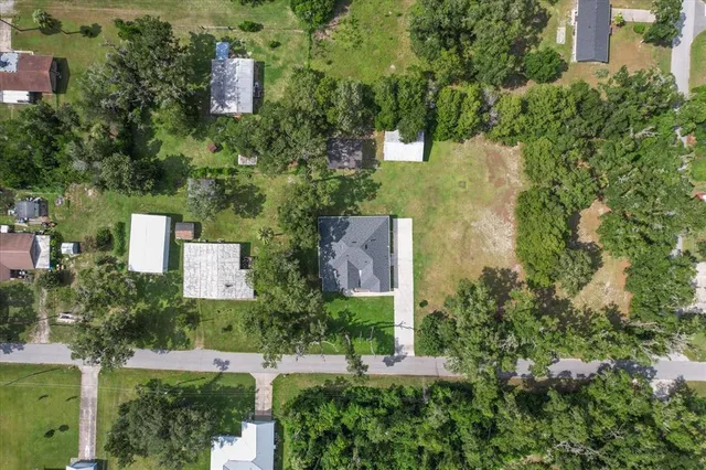 an aerial view of a house with a yard