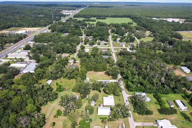 an aerial view of a houses with a yard