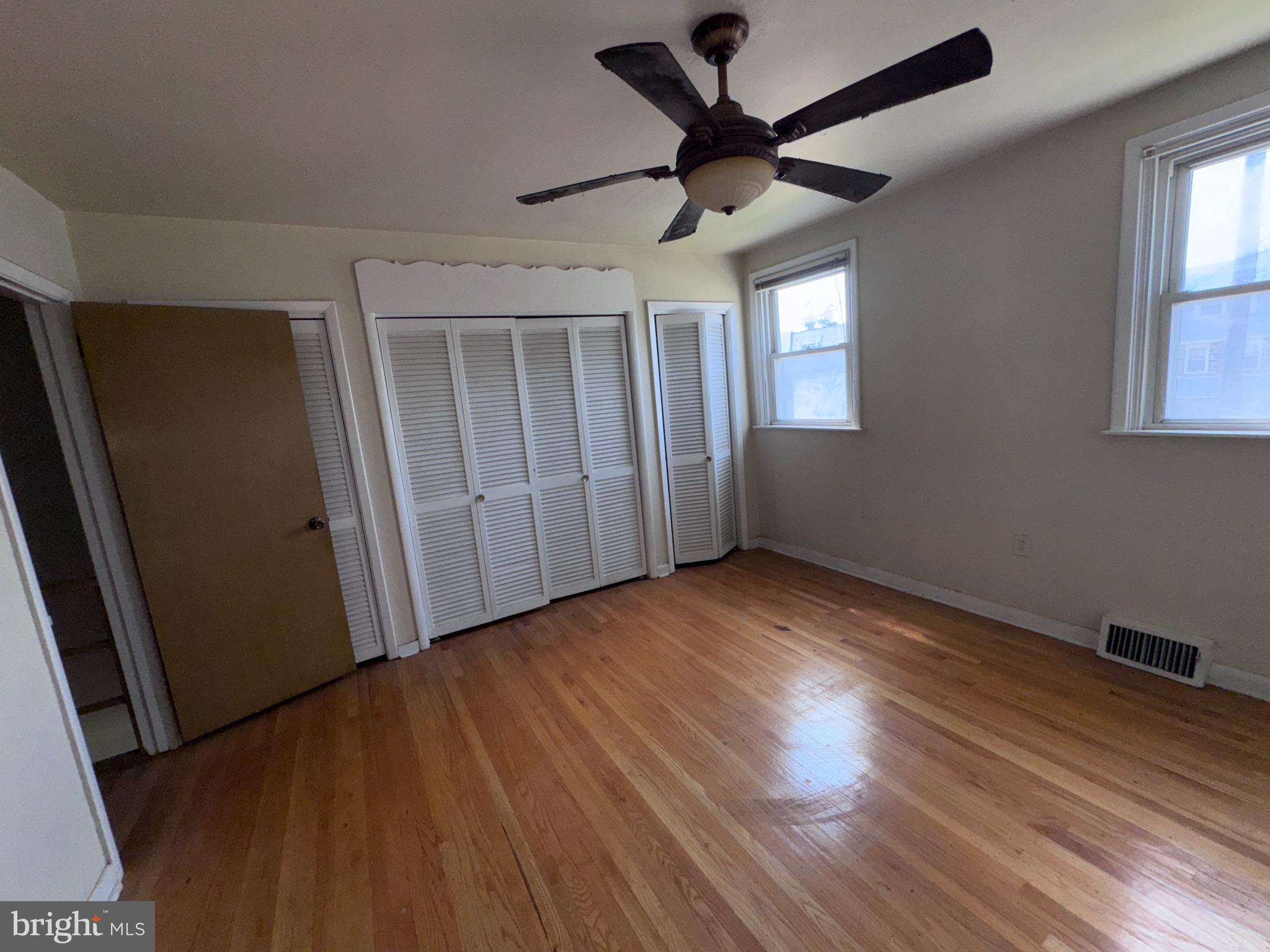 7448 Rhoads Street Philadelphia, PA 19151 - Photo 12 of 17 wooden floor in an empty room with a window