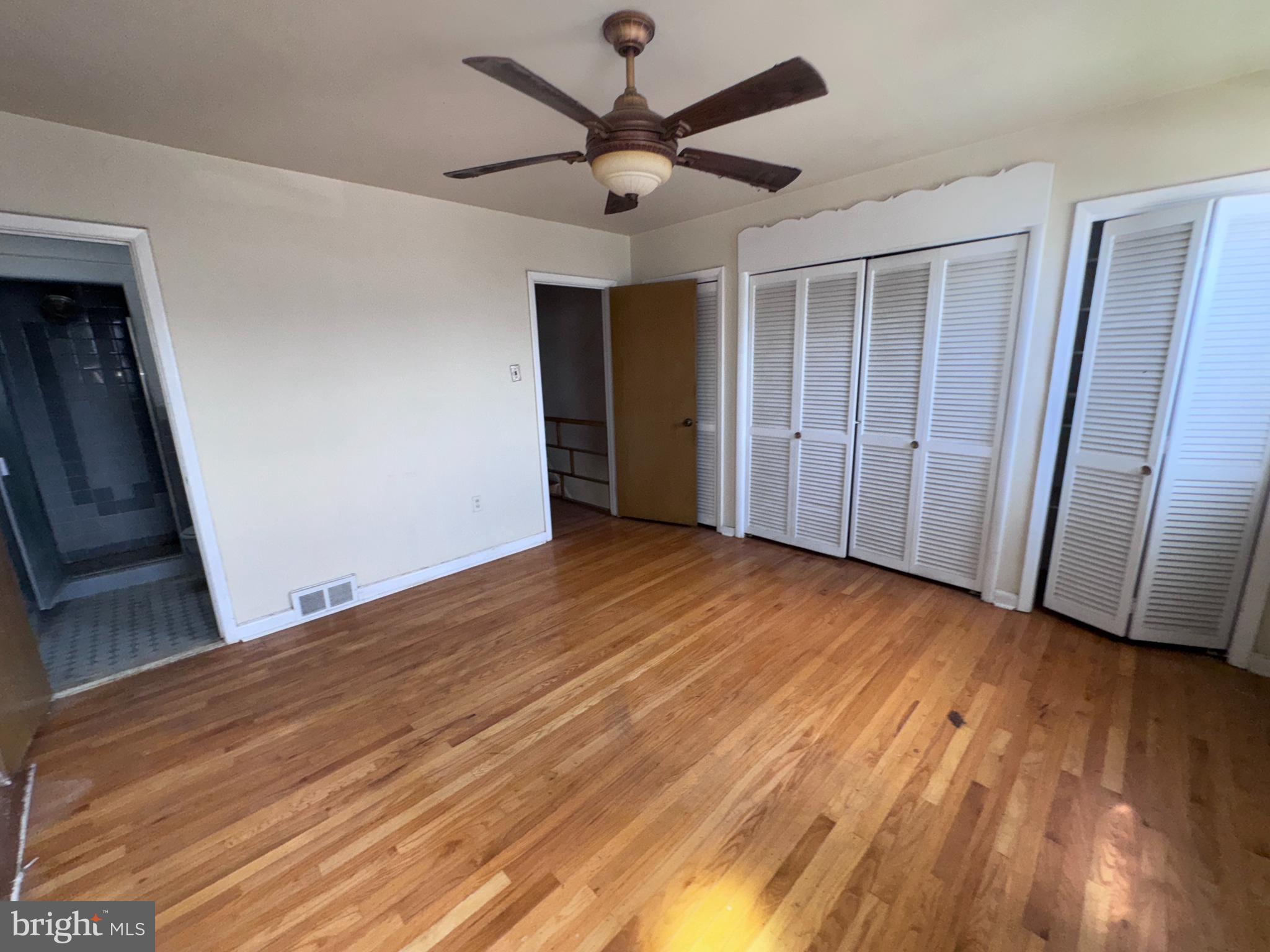 7448 Rhoads Street Philadelphia, PA 19151 - Photo 13 of 17 a view of a livingroom with wooden floor and a ceiling fan