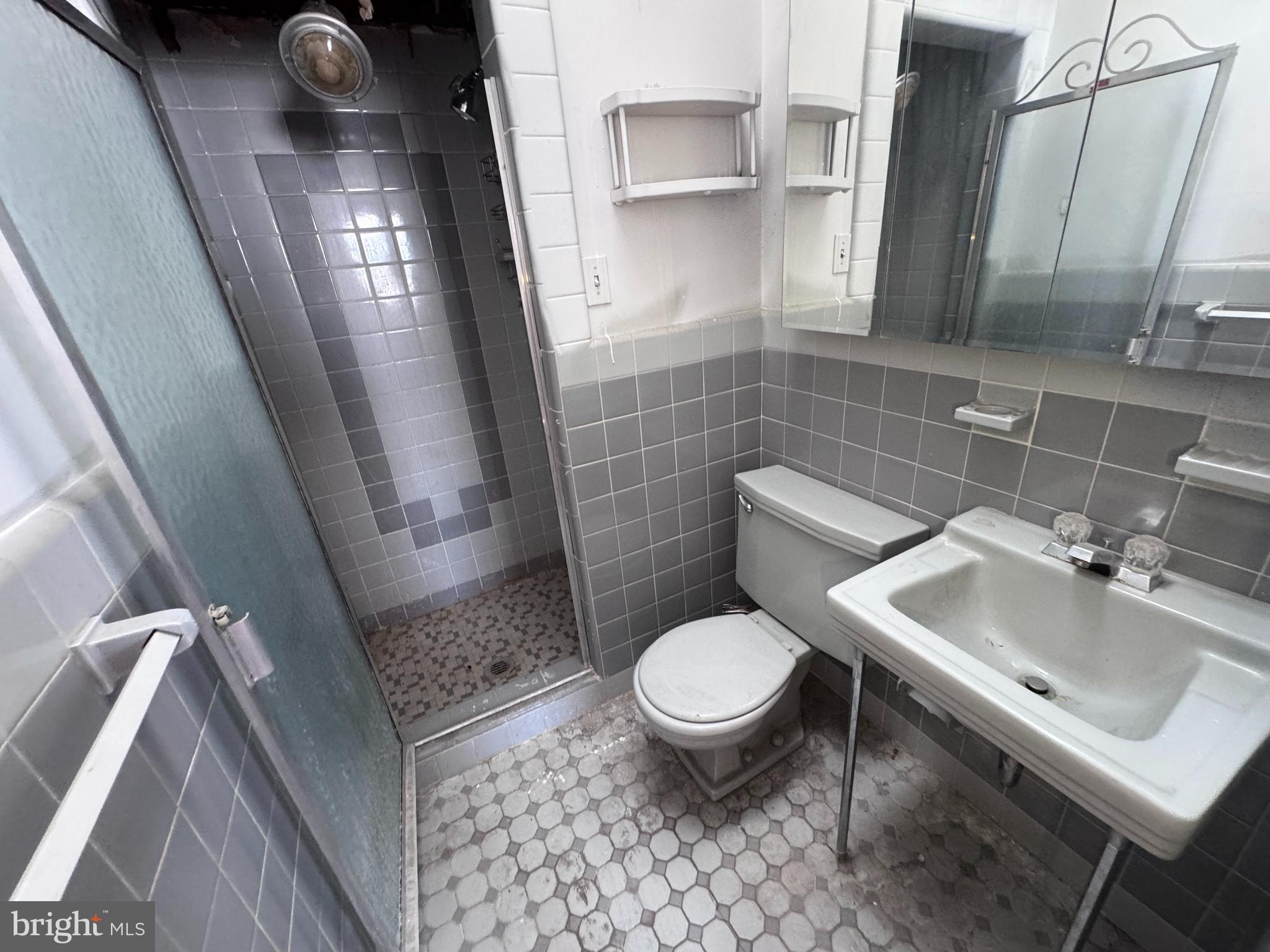 7448 Rhoads Street Philadelphia, PA 19151 - Photo 14 of 17 a bathroom with a sink toilet and shower