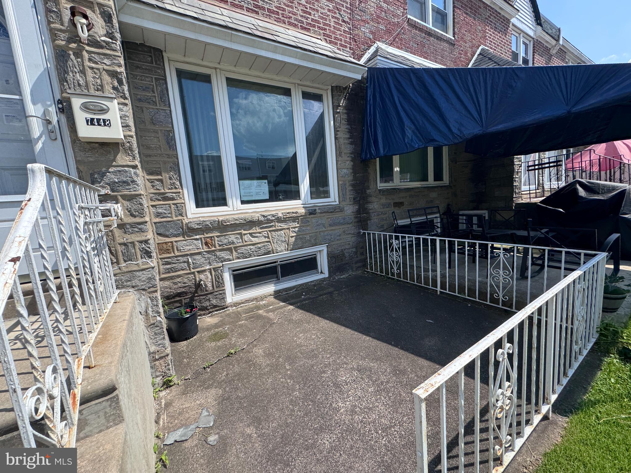 7448 Rhoads Street Philadelphia, PA 19151 - Photo 3 of 17 front view of a house with a porch