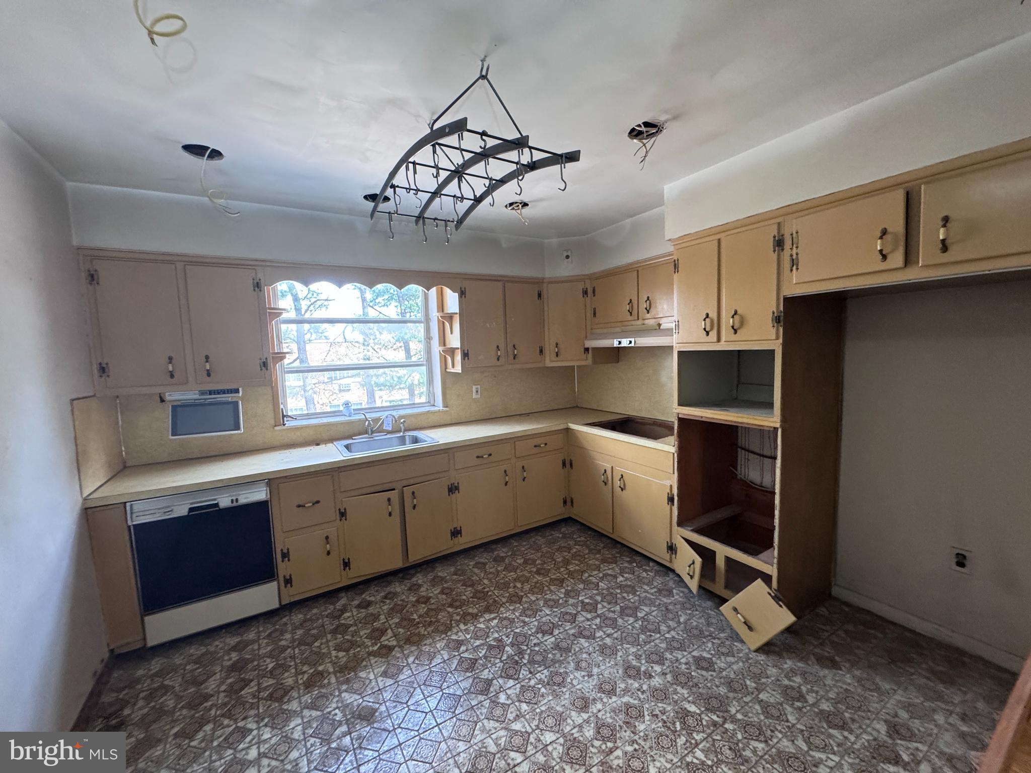 7448 Rhoads Street Philadelphia, PA 19151 - Photo 6 of 17 a kitchen with a stove a sink and a refrigerator