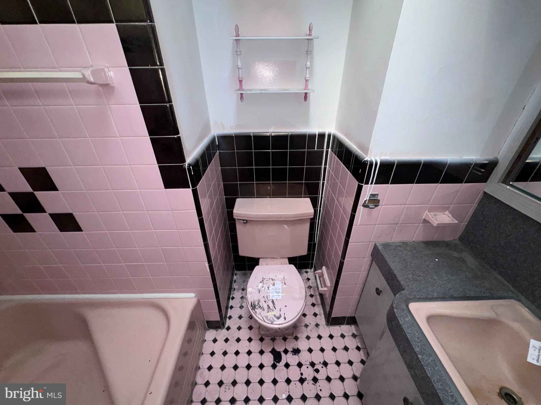 7448 Rhoads Street Philadelphia, PA 19151 - Photo 9 of 17 a bathroom with a sink and a mirror