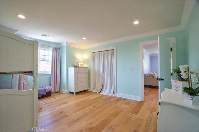 a bedroom with a bunk bed and a dresser