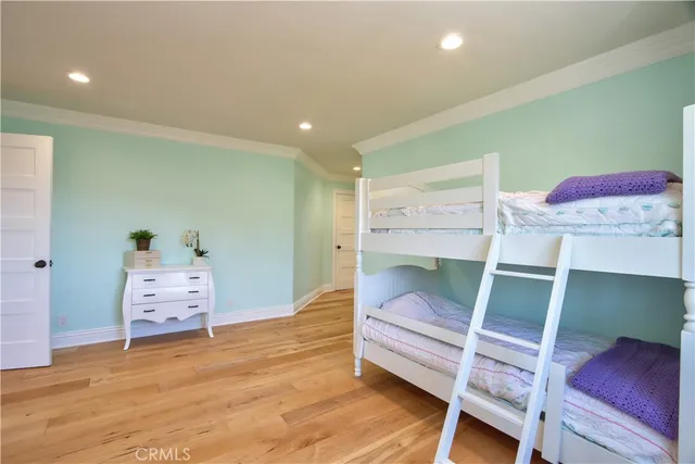 a view of empty room with wooden floor and windows