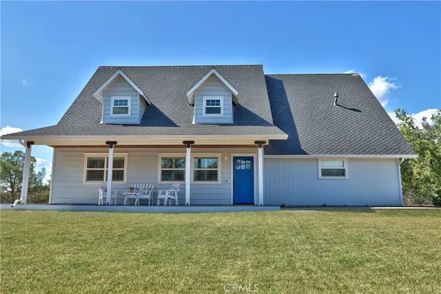 a front view of a house with outdoor seating