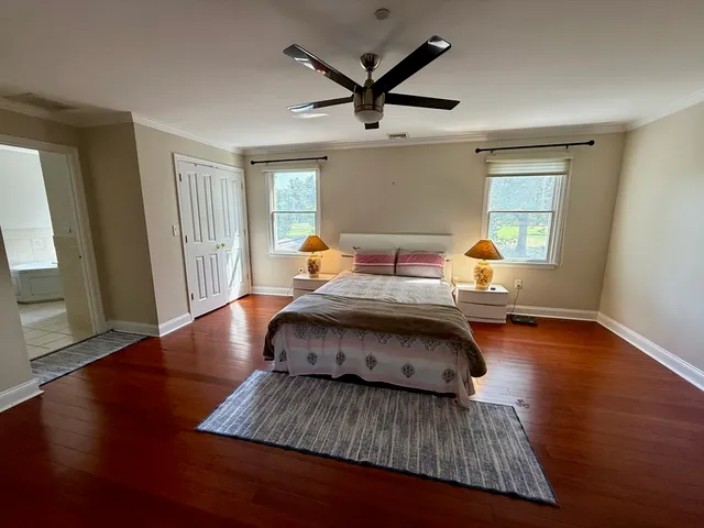 a spacious bedroom with a bed and a chandelier