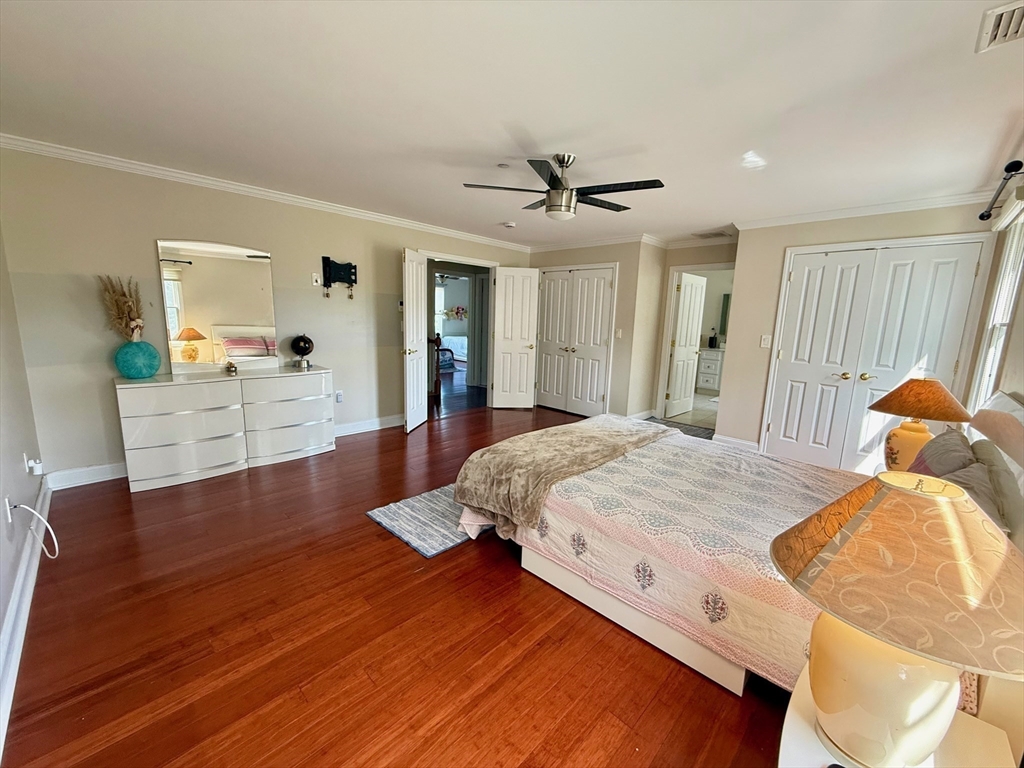 218 Rangeway Road, Unit 213 Billerica, MA 01862 - Photo 17 of 29 a spacious bedroom with a bed and a chandelier