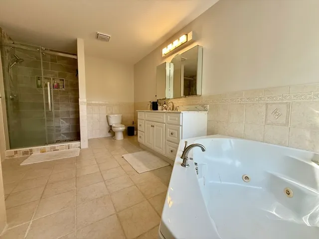 a bathroom with a sink mirror and shower
