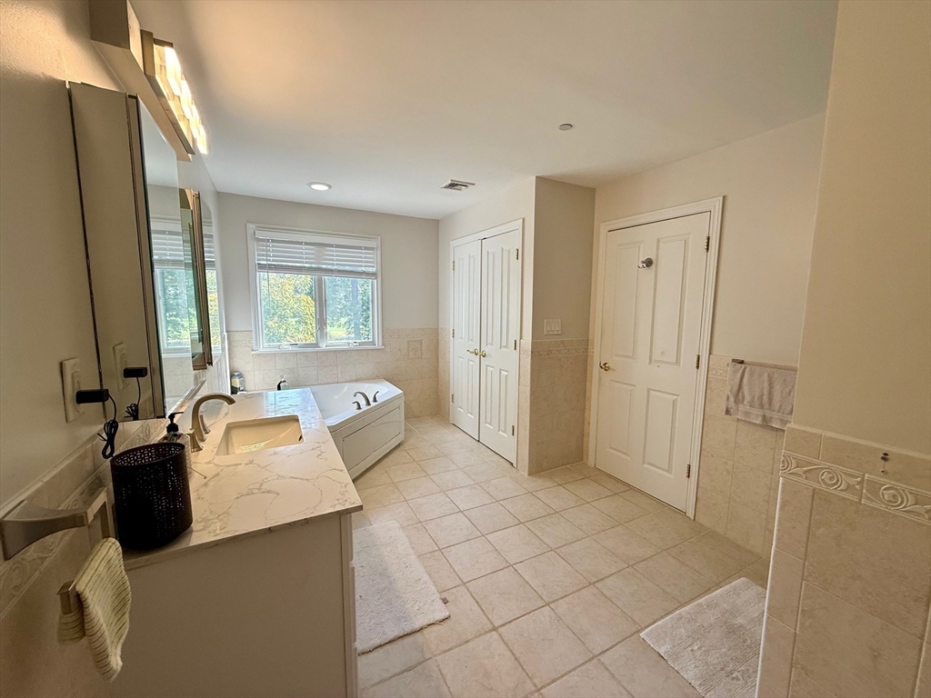 218 Rangeway Road, Unit 213 Billerica, MA 01862 - Photo 20 of 29 a bathroom with a sink mirror and shower