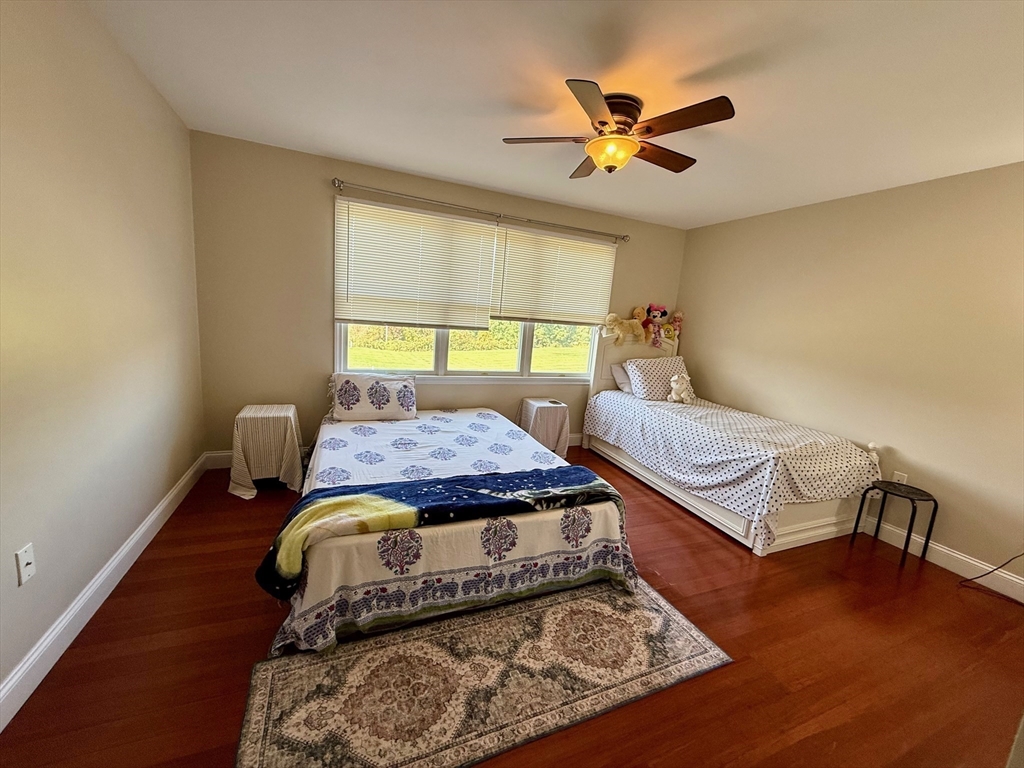 218 Rangeway Road, Unit 213 Billerica, MA 01862 - Photo 21 of 29 a bed sitting in a bedroom next to a window