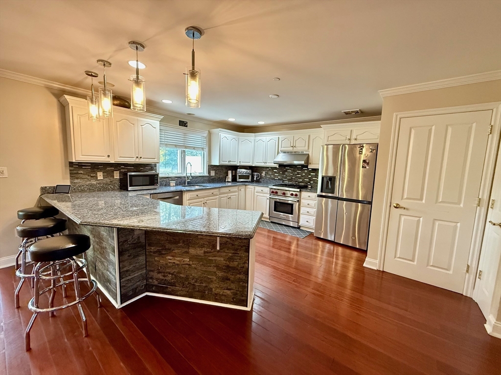 218 Rangeway Road, Unit 213 Billerica, MA 01862 - Photo 9 of 29 a view of kitchen with sink microwave and stove