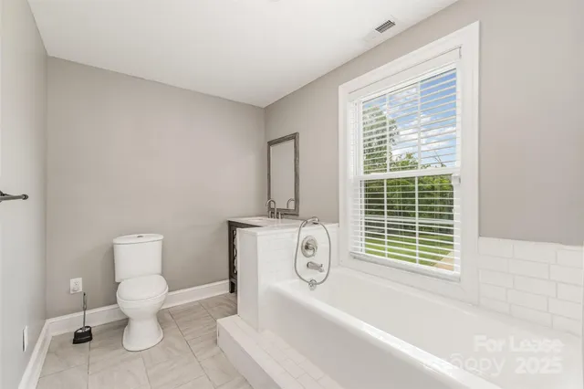 a bathroom with a toilet a sink and a bathtub