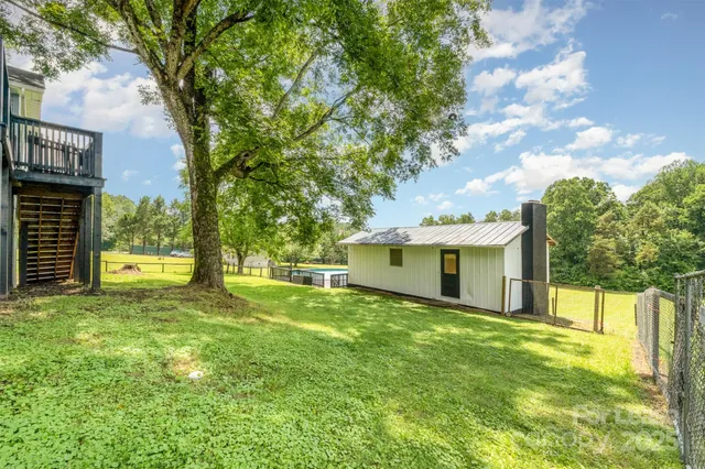a backyard of a house with table and chairs