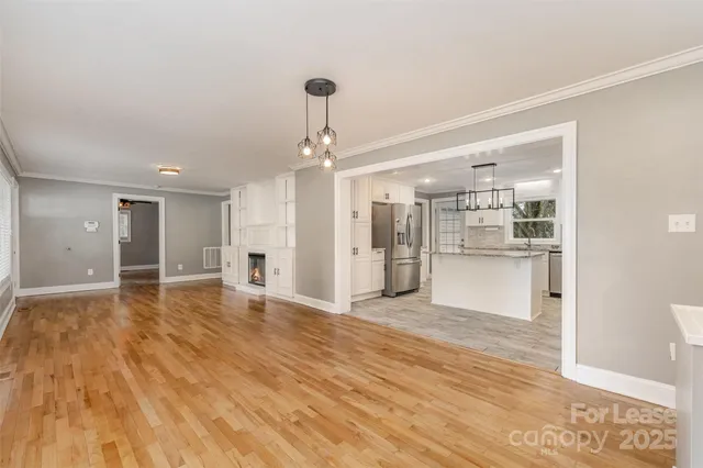 a view of a kitchen with a sink and wooden floor