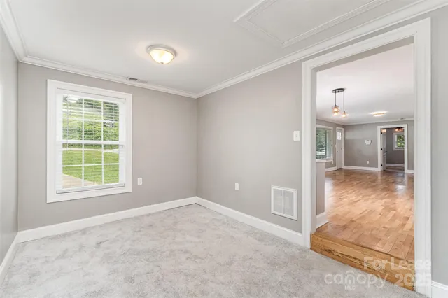 an empty room with entrance and windows