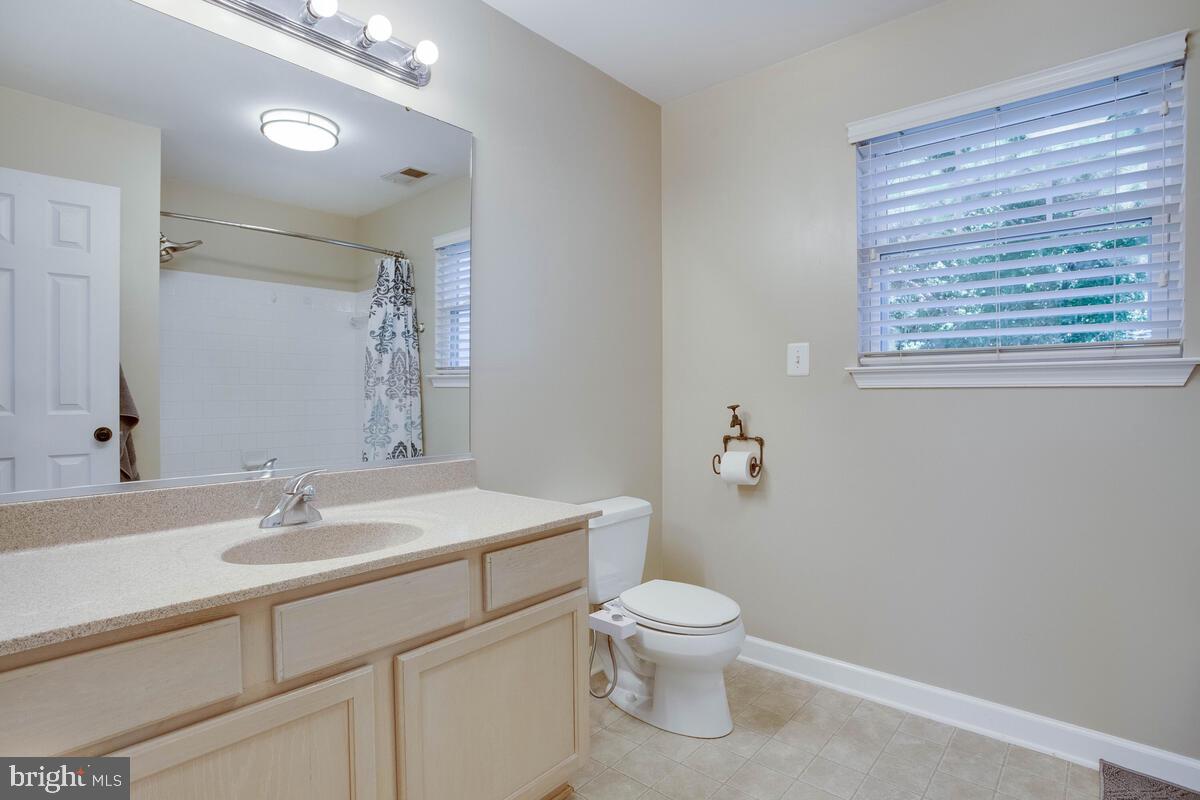 3369 Evans Road Huntingtown, MD 20639 - Photo 38 of 59 a bathroom with a toilet sink and mirror