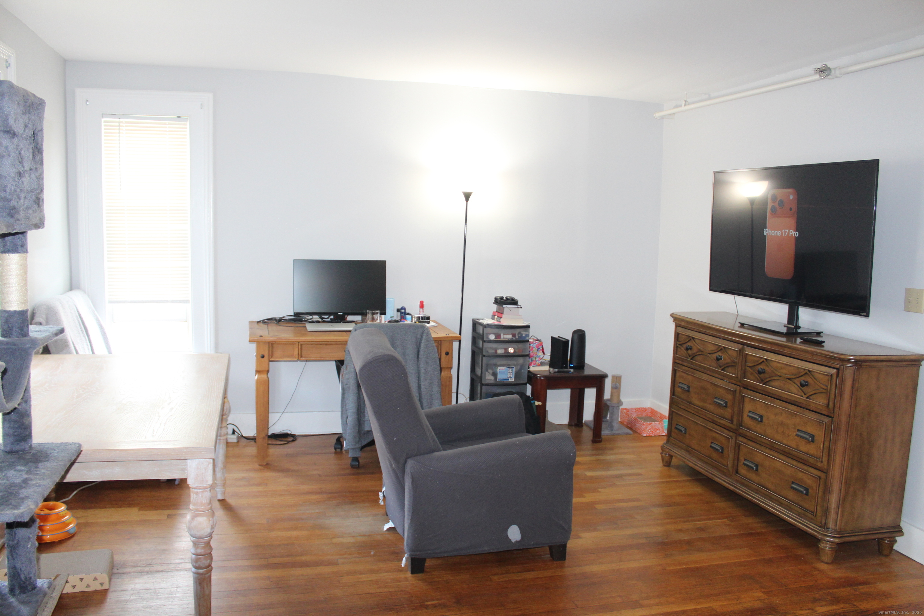 66 Bridge Street, Unit 5 New Milford, CT 06776 - Photo 2 of 16 a living room with furniture and a flat screen tv