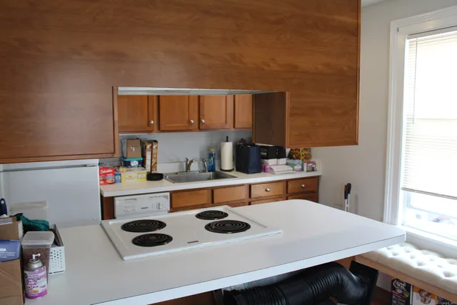 a kitchen with a stove a refrigerator and a sink