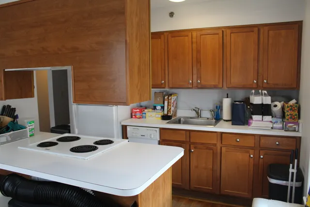a kitchen with a sink a stove and cabinets