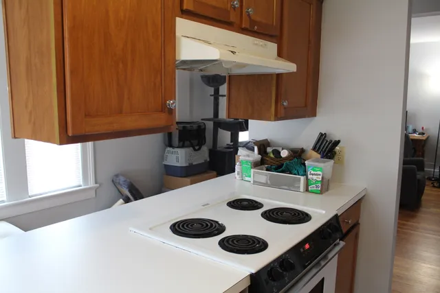 a kitchen with a sink a stove and cabinets