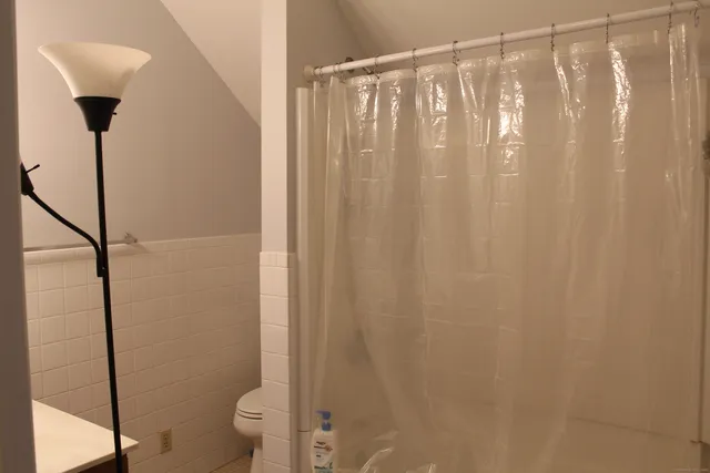 a bathroom with a shower curtain and a sink