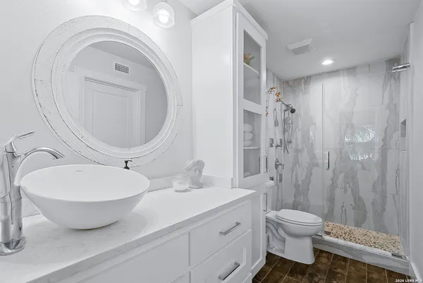 a bedroom with bed and a chandelier