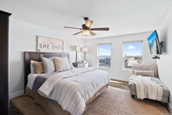 a bathroom with a granite countertop sink a toilet mirror and bathtub