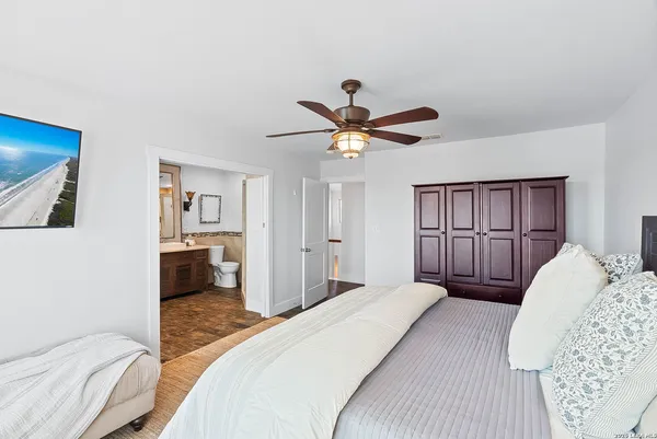 a bathroom with a granite countertop sink a toilet and shower