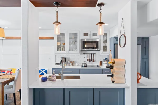 a large kitchen with stainless steel appliances and a sink