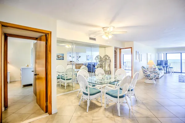 a view of a dining room with furniture and a chandelier