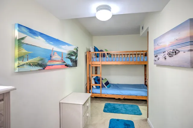 a living room with patio furniture and a wooden floor