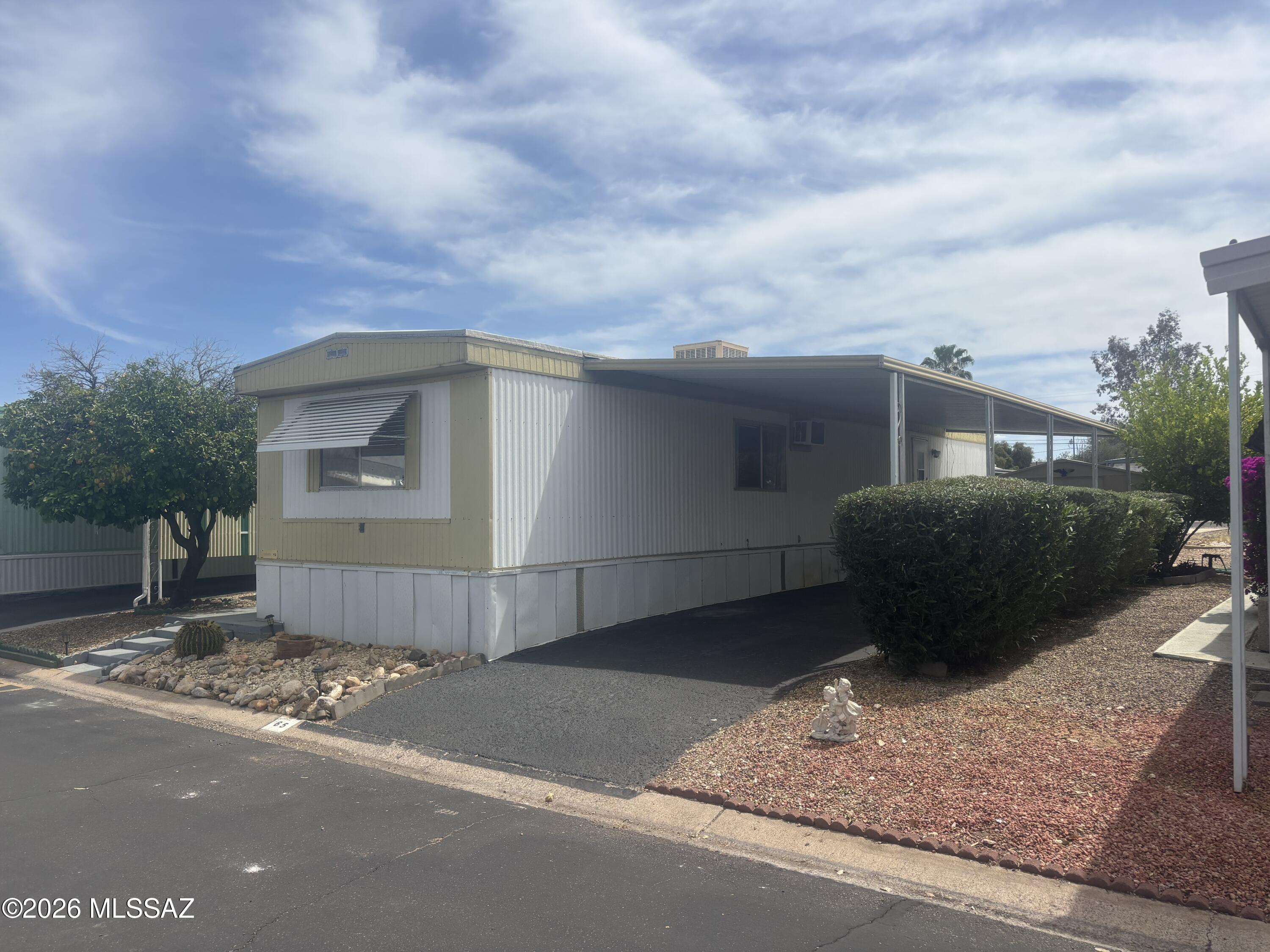 4550 North Flowing Wells Road, Unit 65 Tucson, AZ 85705 - Photo 7 of 50 a view of a house with a yard