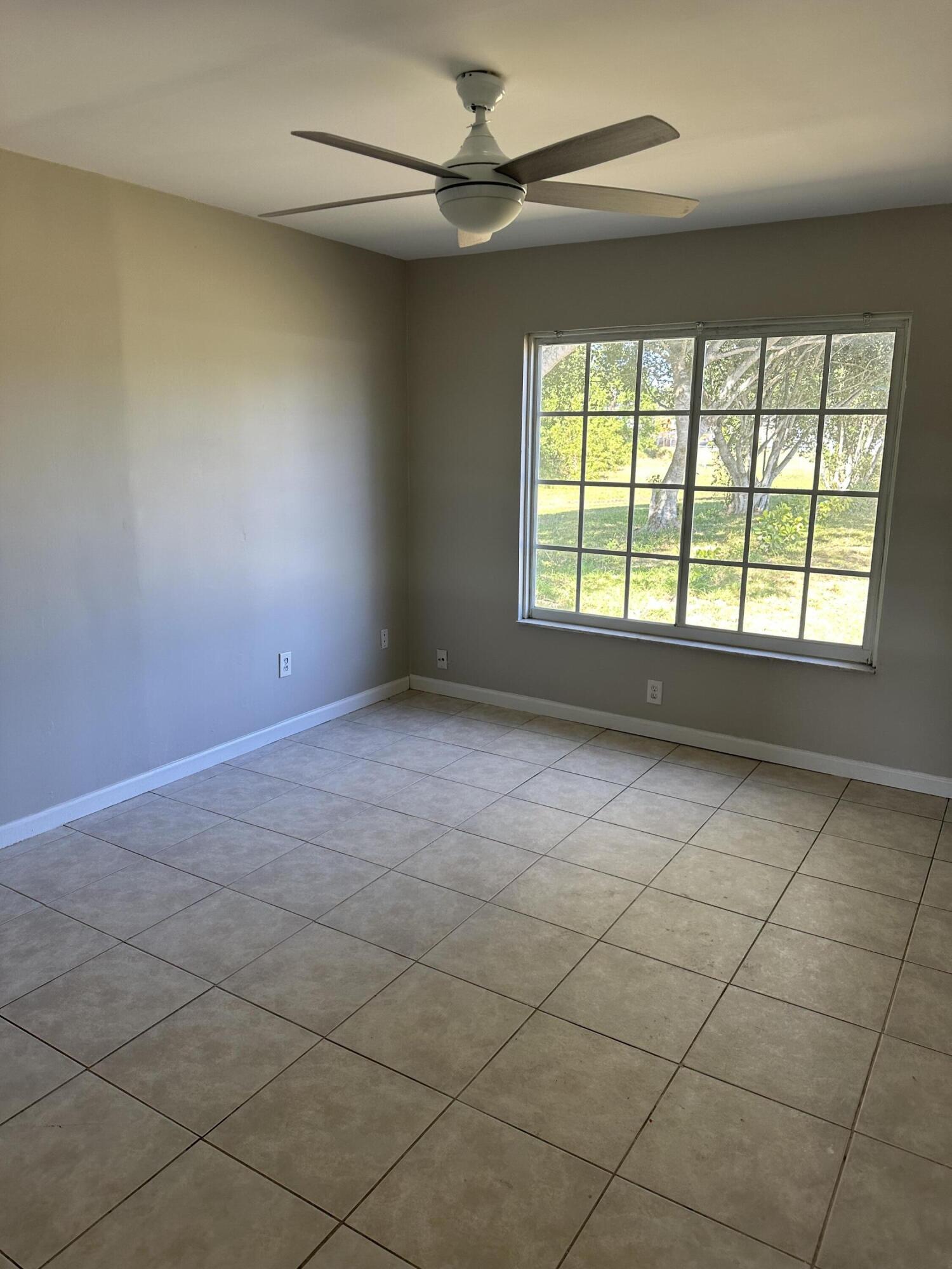 377 Southwest Cherryhill Road Port St. Lucie, FL 34953 - Photo 4 of 9 a view of an empty room with a window