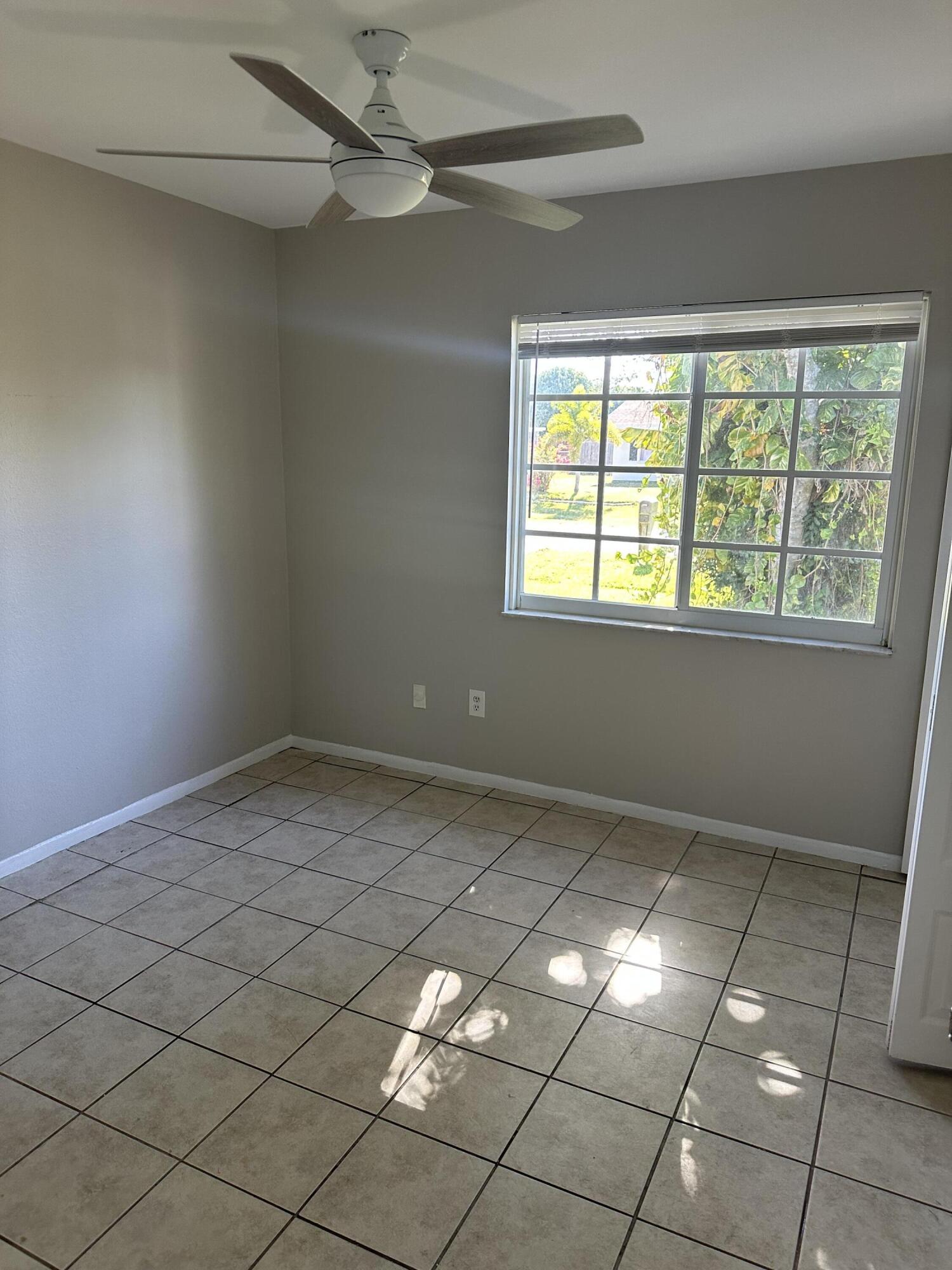 377 Southwest Cherryhill Road Port St. Lucie, FL 34953 - Photo 7 of 9 a view of an empty room and window
