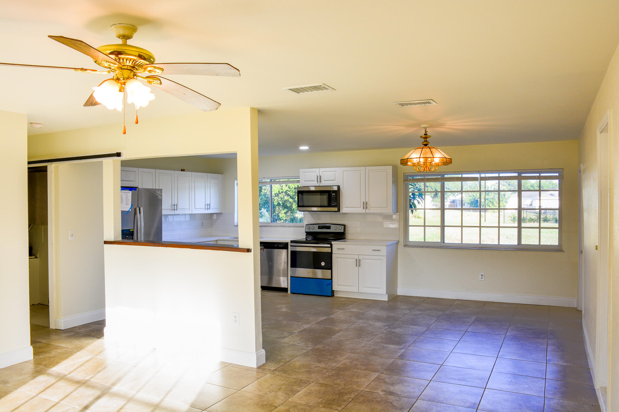 377 Southwest Cherryhill Road Port St. Lucie, FL 34953 - Photo 8 of 9 a kitchen with stainless steel appliances kitchen island granite countertop a refrigerator and a sink